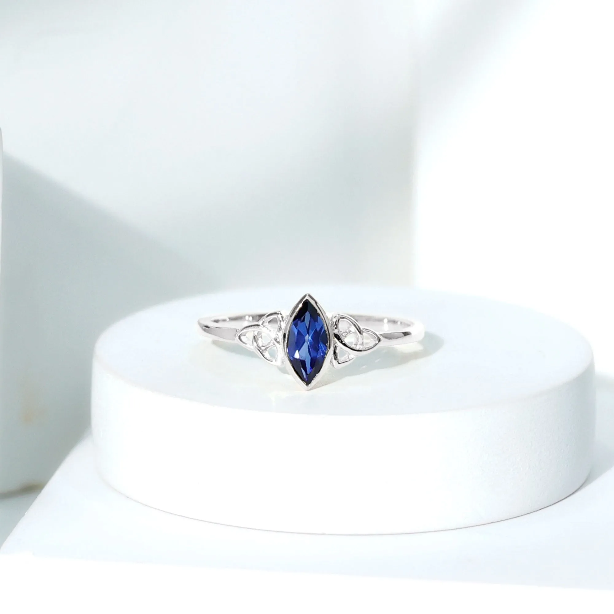 Marquise Cut Created Blue Sapphire Solitaire Celtic Knot Ring in Bezel Setting