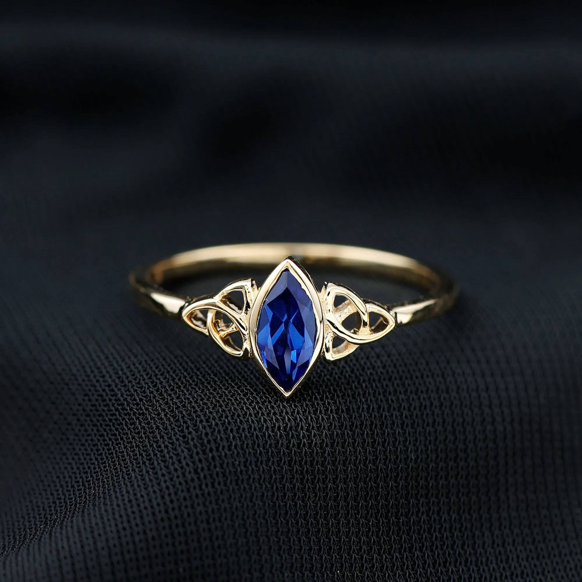 Marquise Cut Created Blue Sapphire Solitaire Celtic Knot Ring in Bezel Setting