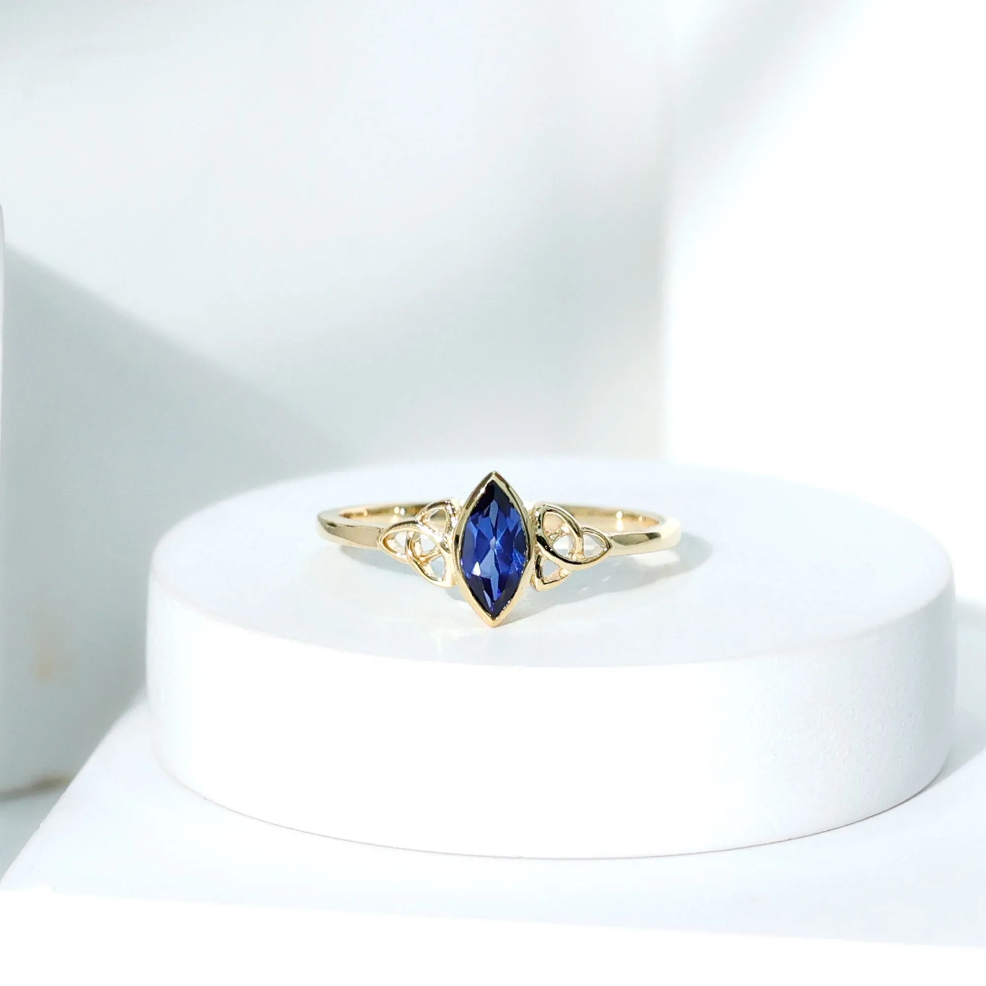 Marquise Cut Created Blue Sapphire Solitaire Celtic Knot Ring in Bezel Setting