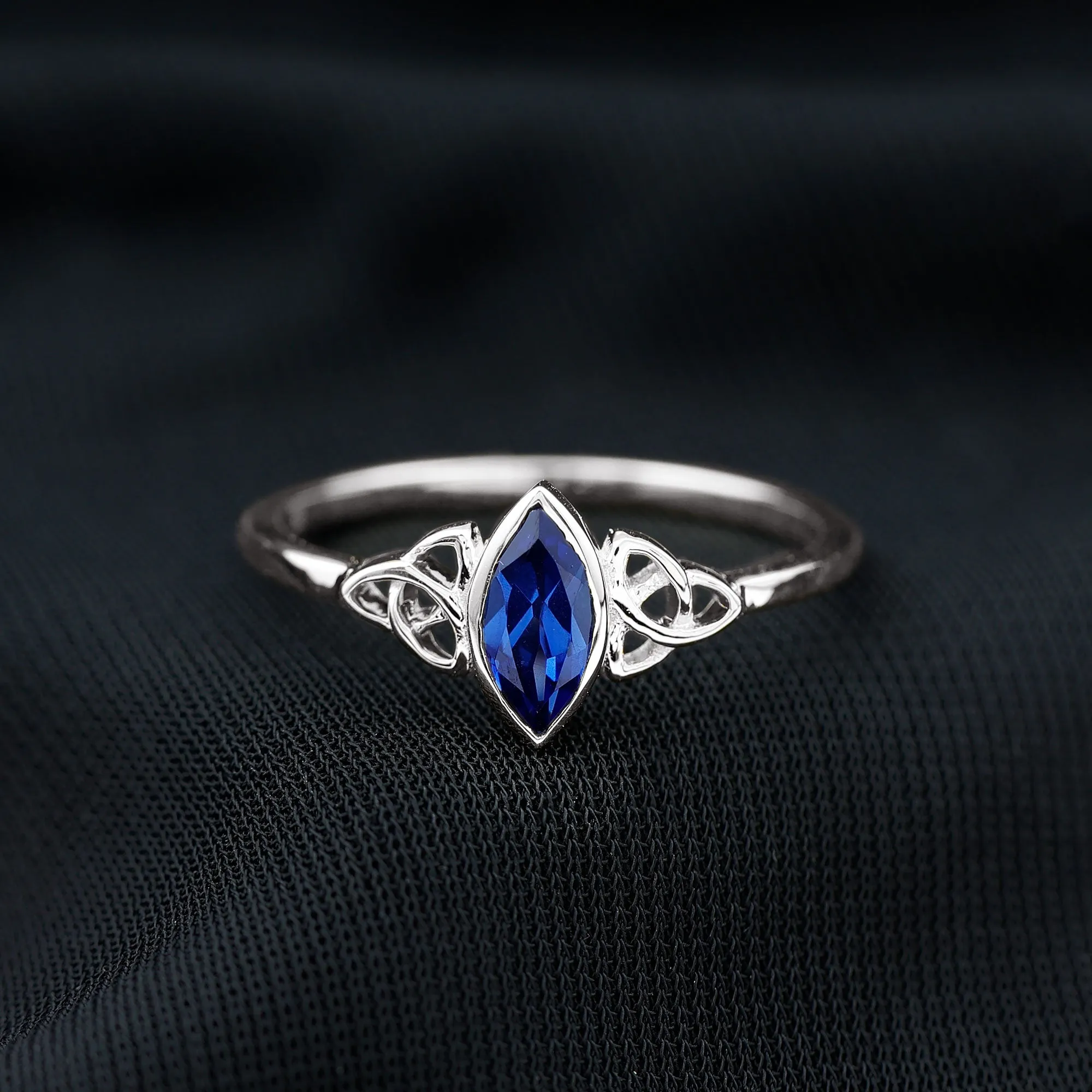 Marquise Cut Created Blue Sapphire Solitaire Celtic Knot Ring in Bezel Setting