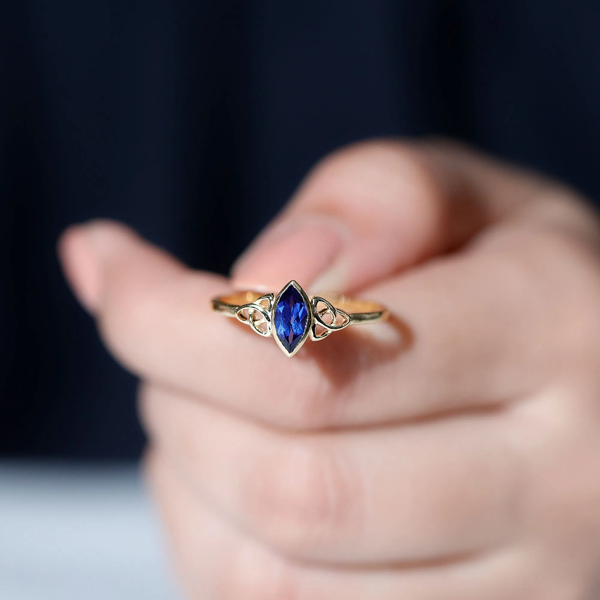 Marquise Cut Created Blue Sapphire Solitaire Celtic Knot Ring in Bezel Setting